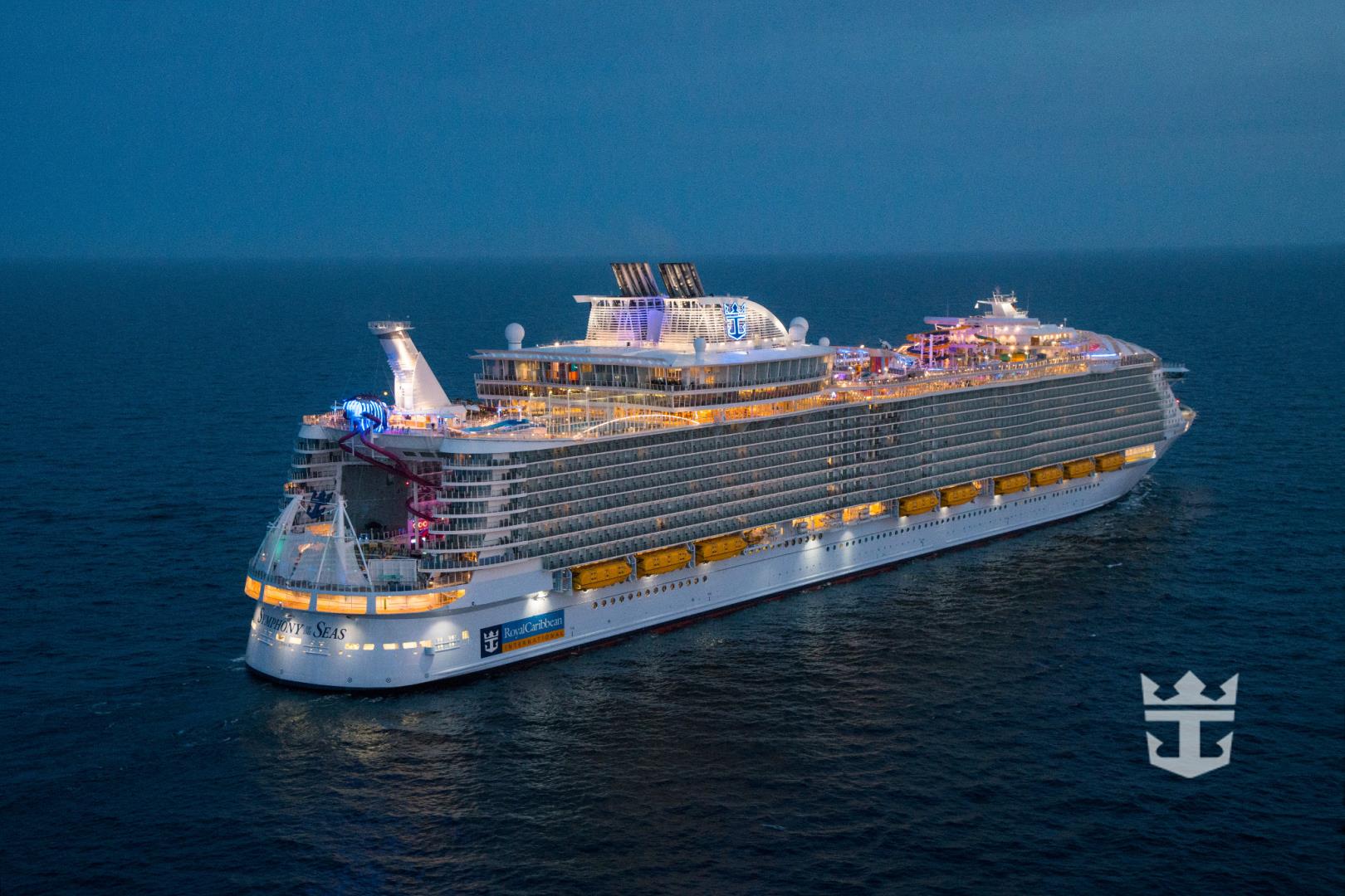 Aerial view of Symphony of the Seas at night offshore Barcelona, Spain